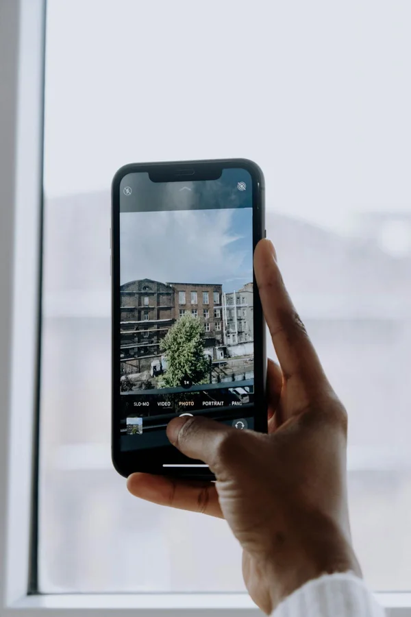 Phone camera pointed at a city building during an outdoor clue walk